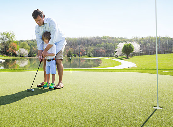 man playing golf with child